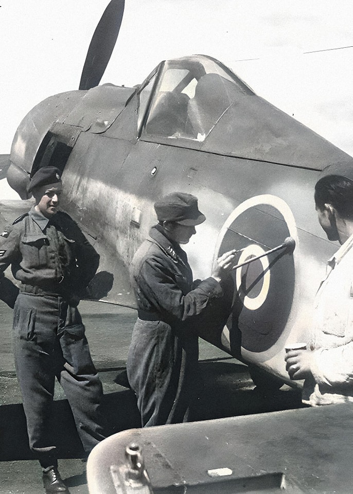Captured German FW-190 getting an RAF roundel painted on the fuselage.jpg