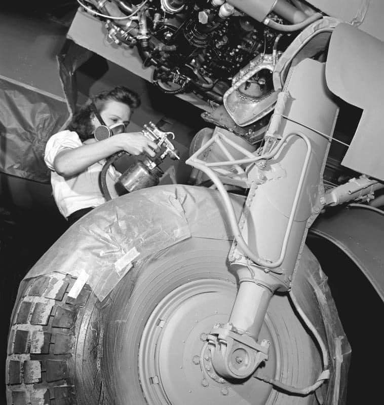 A Female Worker Spray Paints the Landing Gear of a De Havilland Mosquito Airplane. Downsview, ...jpg