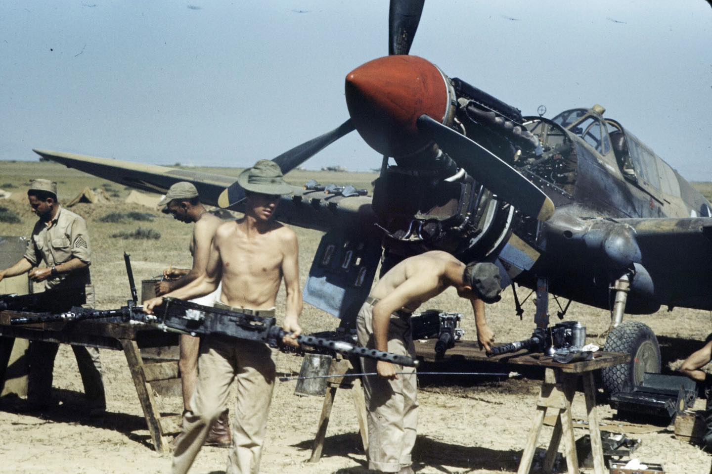 Armorers working on the ANM2 .50 cal Browning machine guns from a Curtiss P-40K Warhawk in Tun...jpg