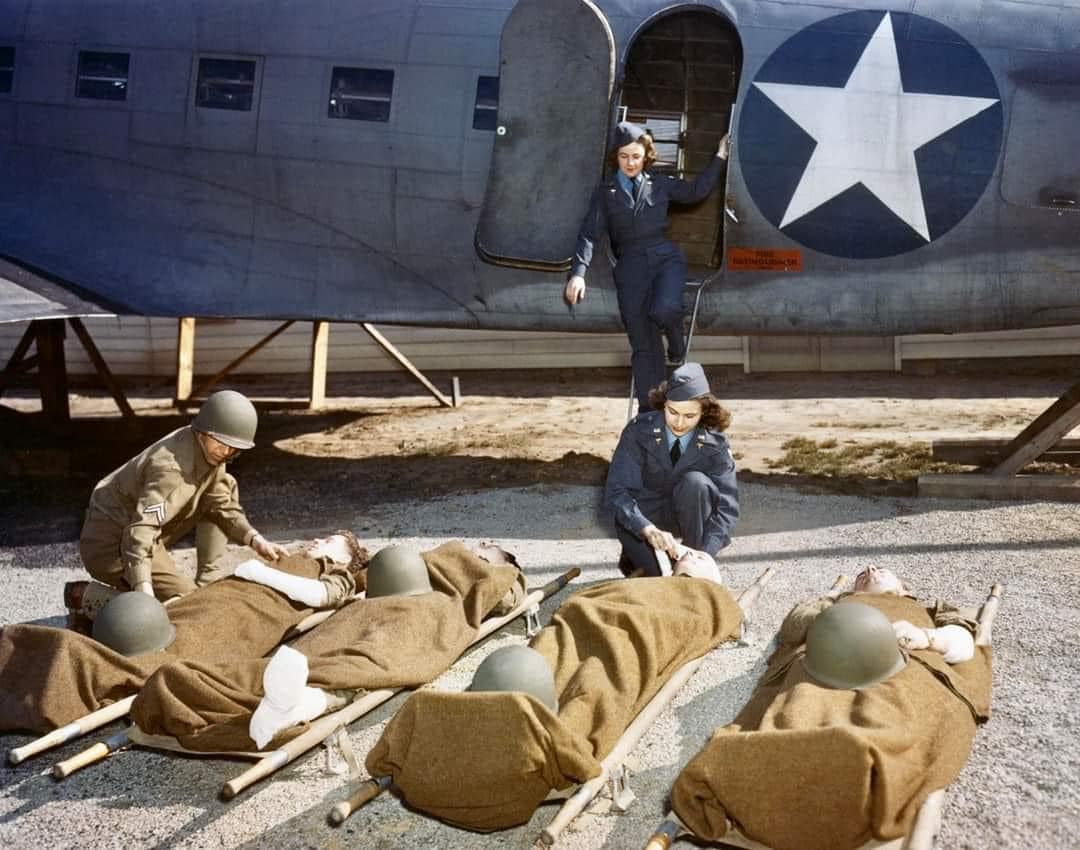 Flight Nurses training to evacuate patients aboard a mock-up of C-47 transport.jpg