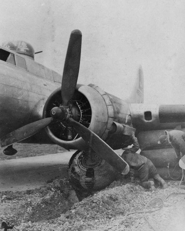 Ground personnel inflate air cushions to raise a crashed B-17.jpg