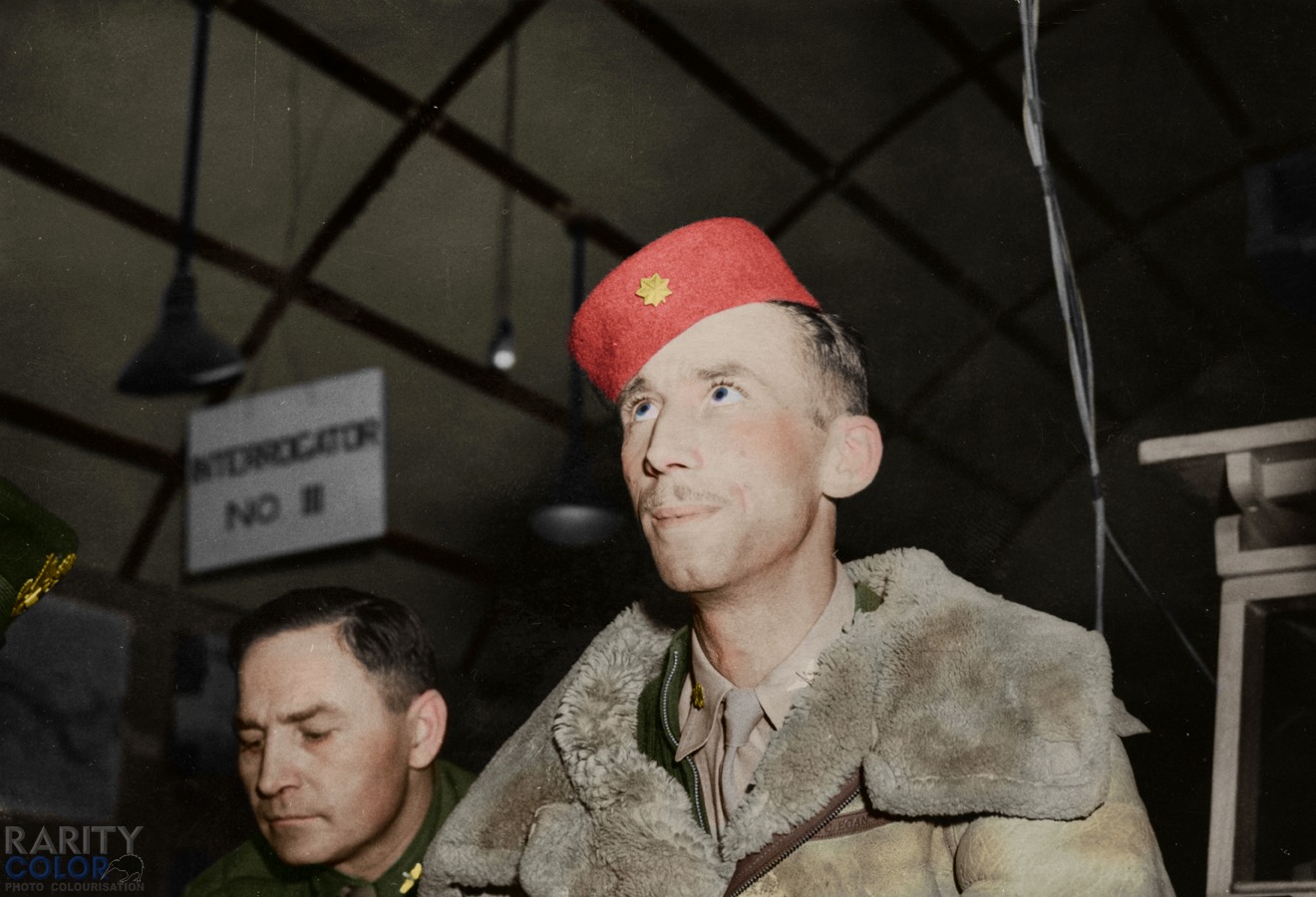 Major John 'Bucky' Egan of the 100th Bomb group wearing his distinctive white bomber jacket an...jpg